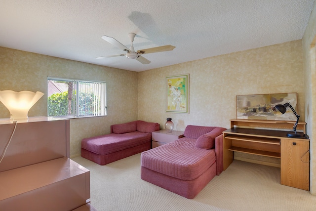 living room with a textured ceiling, ceiling fan, and light carpet