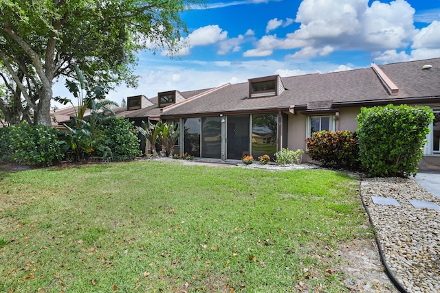 back of house featuring a yard