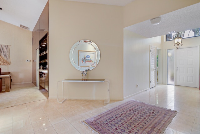 tiled foyer with a high ceiling