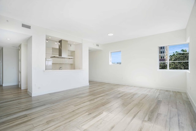 unfurnished living room with plenty of natural light and light wood-type flooring