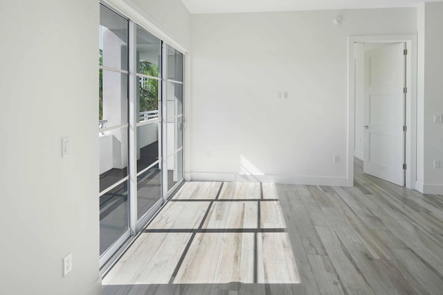 unfurnished room with light hardwood / wood-style flooring