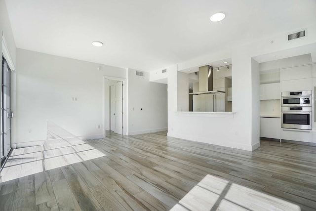 unfurnished living room featuring light hardwood / wood-style floors