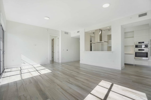 unfurnished living room with light wood-type flooring