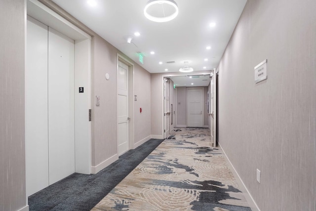 corridor with dark carpet and elevator