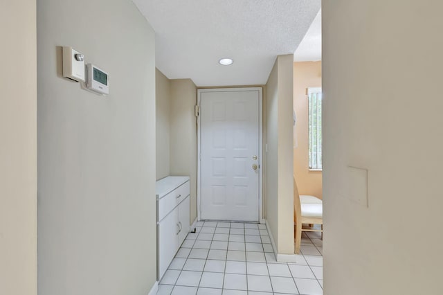 bathroom featuring tile patterned flooring and a textured ceiling