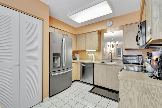 kitchen featuring sink, decorative light fixtures, light brown cabinetry, a notable chandelier, and stainless steel appliances