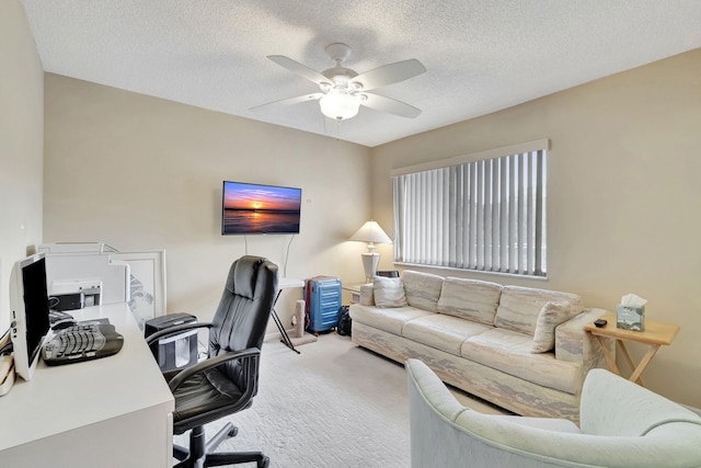 office area featuring carpet flooring, ceiling fan, and a textured ceiling