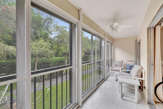 sunroom / solarium featuring ceiling fan