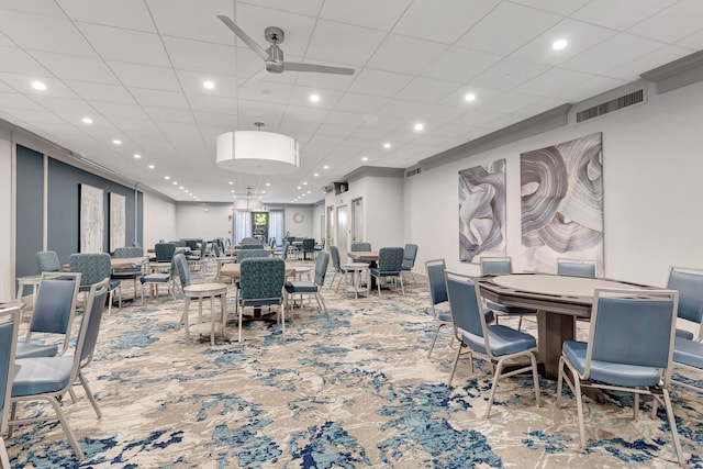 dining space featuring ceiling fan and ornamental molding