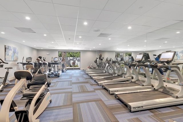 workout area featuring carpet flooring and a drop ceiling