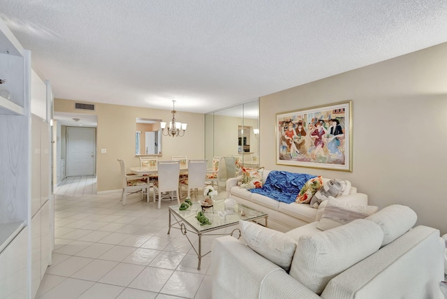 tiled living room featuring a textured ceiling and an inviting chandelier