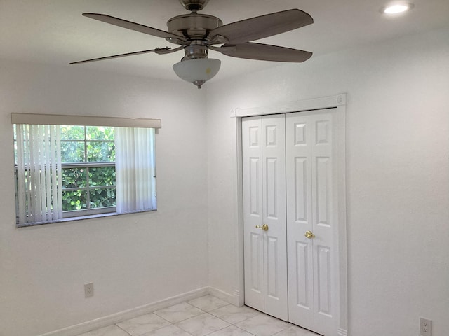 unfurnished bedroom featuring a closet, ceiling fan, and light tile floors