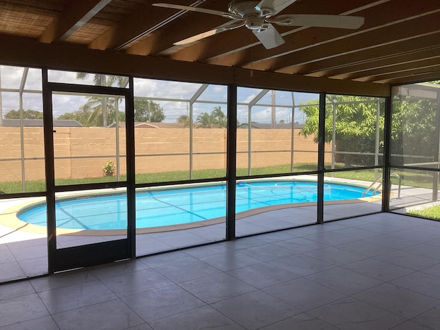 view of pool featuring glass enclosure, ceiling fan, and a patio area