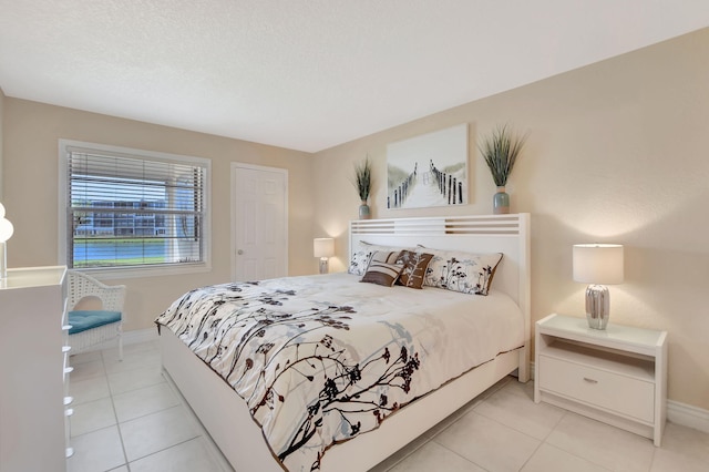 bedroom featuring light tile floors