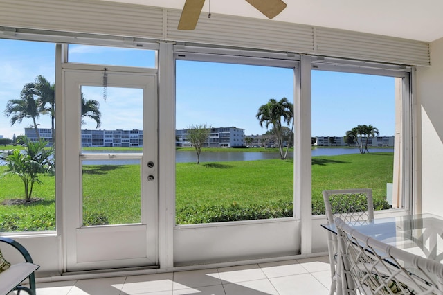 sunroom featuring a water view, a healthy amount of sunlight, and ceiling fan