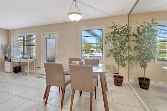 dining area featuring light tile floors