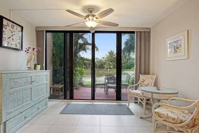 doorway to outside with expansive windows, ceiling fan, and light tile flooring