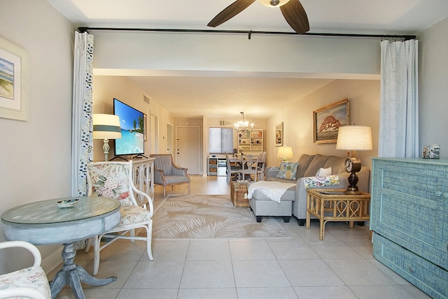 living room featuring light tile floors and ceiling fan with notable chandelier