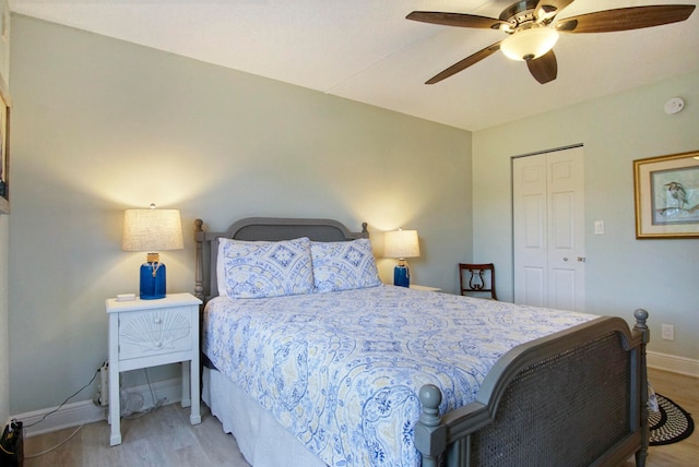 bedroom with a closet, ceiling fan, and light hardwood / wood-style flooring