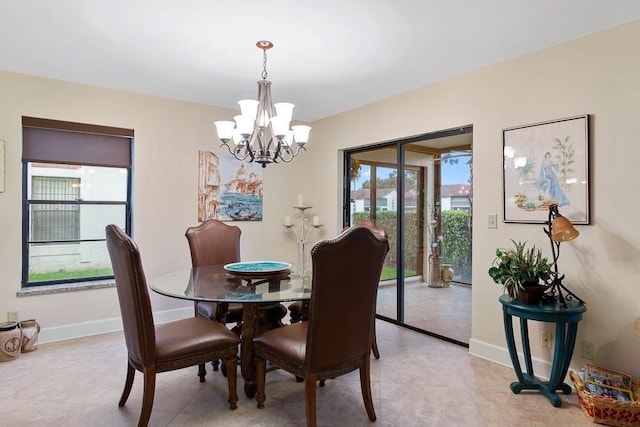 dining area featuring an inviting chandelier and light tile patterned floors