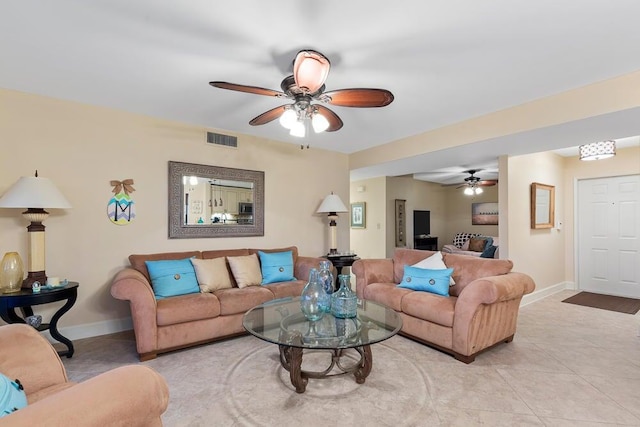 tiled living room with ceiling fan