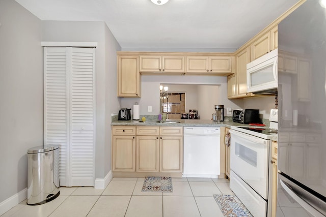 kitchen featuring light tile floors, white appliances, and a notable chandelier