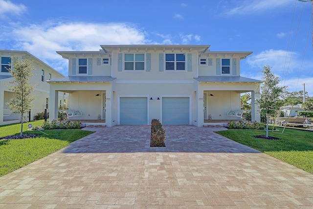 view of front facade with a porch, a garage, and a front yard