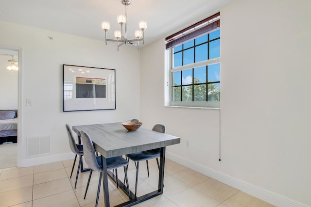 dining area featuring light tile floors and ceiling fan with notable chandelier