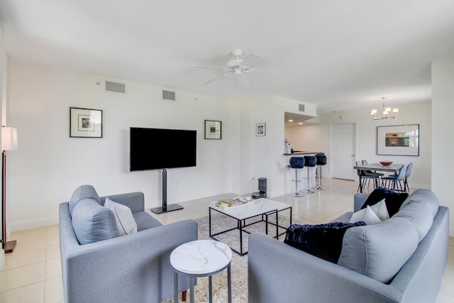 living room featuring ceiling fan with notable chandelier and light tile flooring