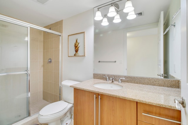 bathroom with a shower with shower door, oversized vanity, and toilet