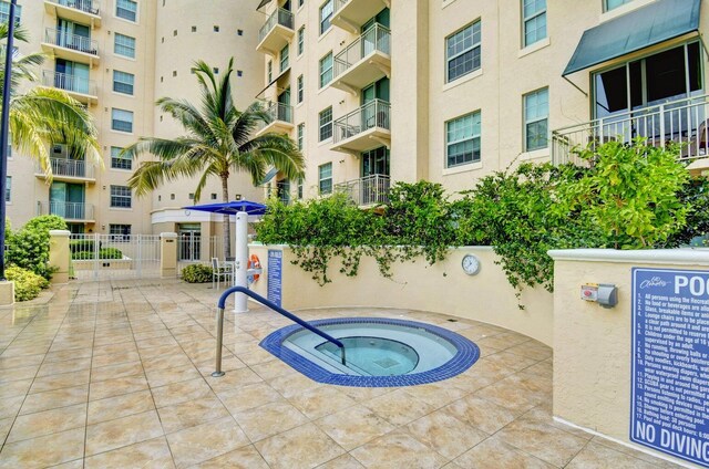 view of swimming pool featuring a community hot tub