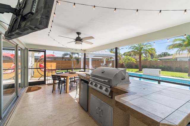 view of patio / terrace featuring an outdoor kitchen, a fenced in pool, a fenced backyard, grilling area, and outdoor dining space