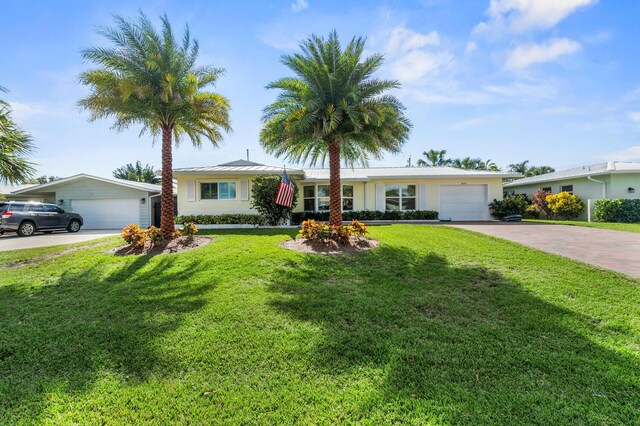 ranch-style home with a front yard and a garage