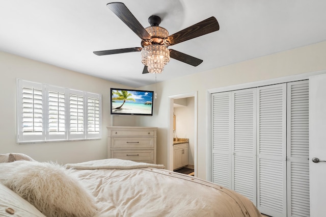 bedroom featuring ceiling fan, a closet, and ensuite bath