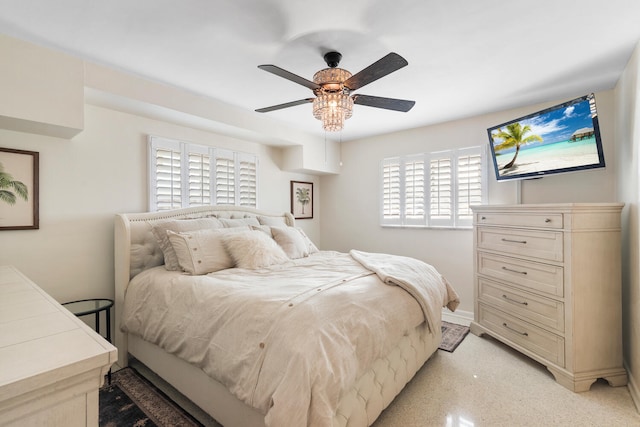 bedroom featuring light speckled floor, a ceiling fan, and baseboards