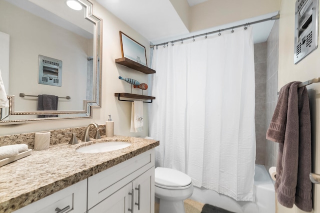 bathroom featuring toilet, shower / bath combination with curtain, and vanity