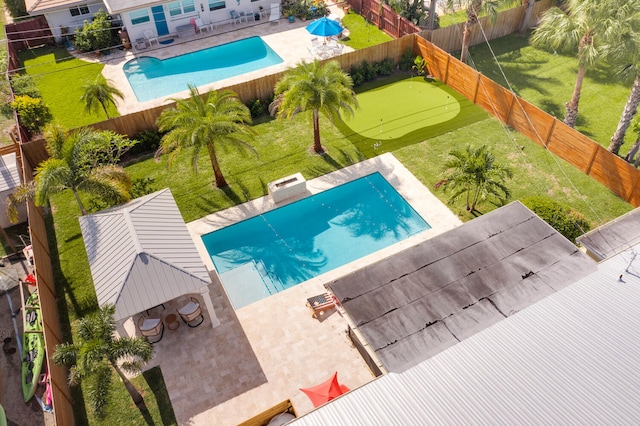 view of pool featuring a fenced in pool, a patio area, a fenced backyard, and a gazebo