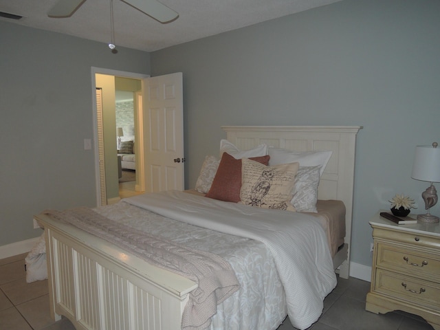 tiled spare room with ceiling fan