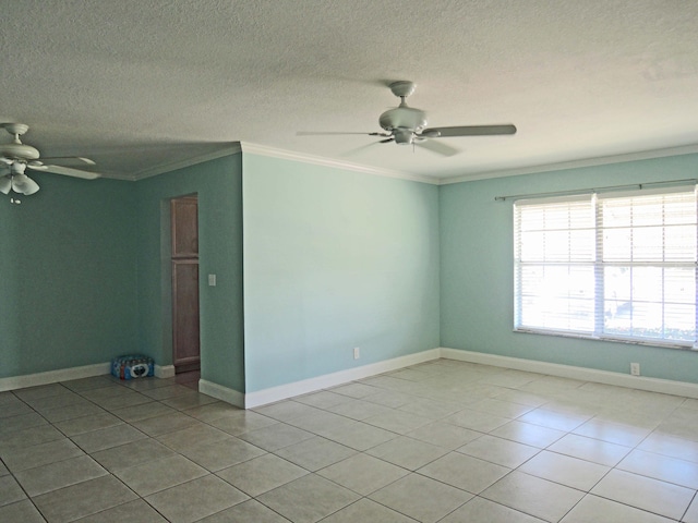 spare room featuring crown molding, a textured ceiling, ceiling fan, and light tile floors