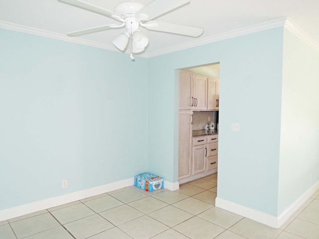 empty room featuring crown molding, ceiling fan, and light tile floors