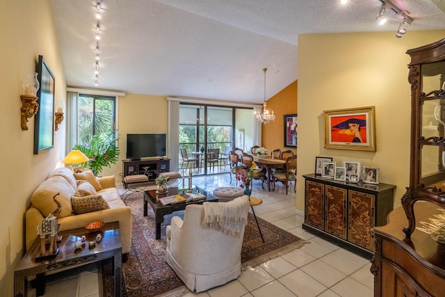 living room featuring vaulted ceiling, light tile patterned flooring, an inviting chandelier, rail lighting, and a textured ceiling