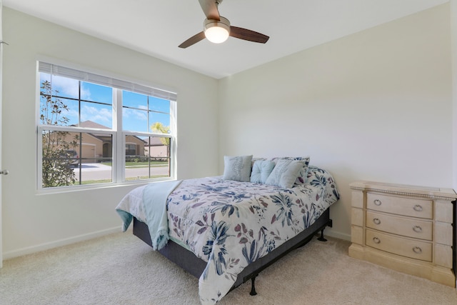 bedroom featuring light carpet and ceiling fan