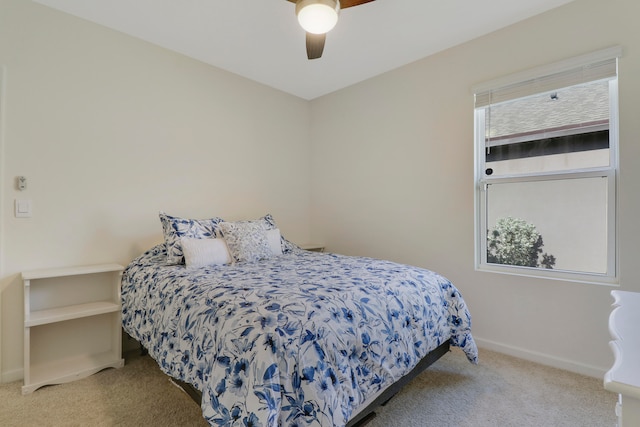 carpeted bedroom featuring ceiling fan and multiple windows