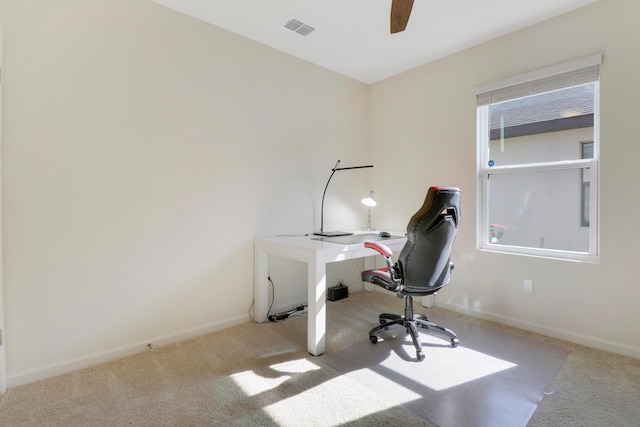 carpeted office with ceiling fan