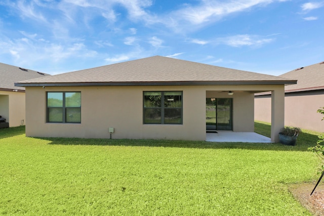 back of house with ceiling fan, a lawn, and a patio area