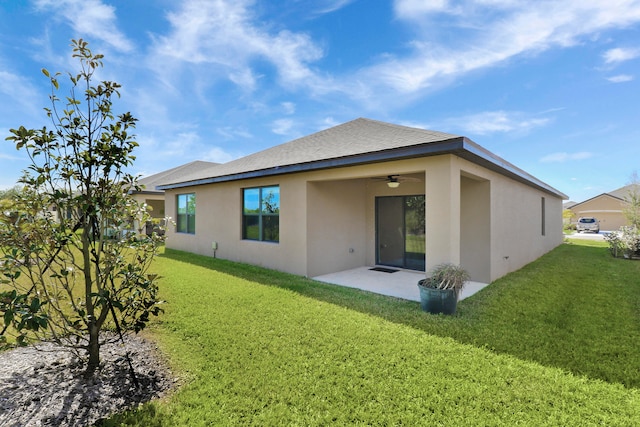 rear view of property featuring a patio area, ceiling fan, and a yard