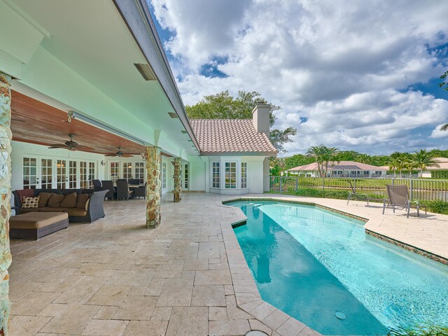 view of pool with a patio, french doors, ceiling fan, and an outdoor hangout area