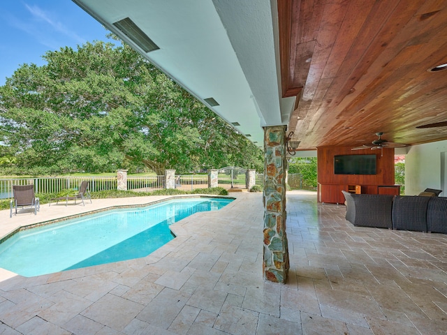 view of swimming pool featuring a patio area, ceiling fan, and an outdoor hangout area