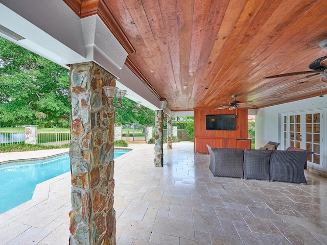 view of terrace featuring a fenced in pool, an outdoor living space, and ceiling fan