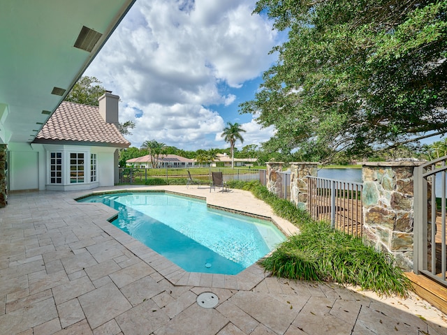 view of pool with a patio area and french doors